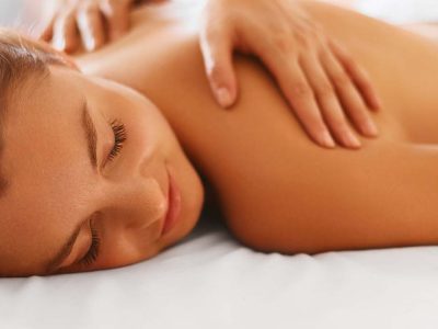 Spa woman. Female enjoying relaxing back massage in cosmetology spa centre. Body care, skin care, wellness, wellbeing, beauty treatment concept.